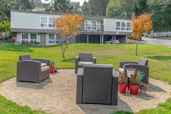 A patio with chairs and a table in front of a building